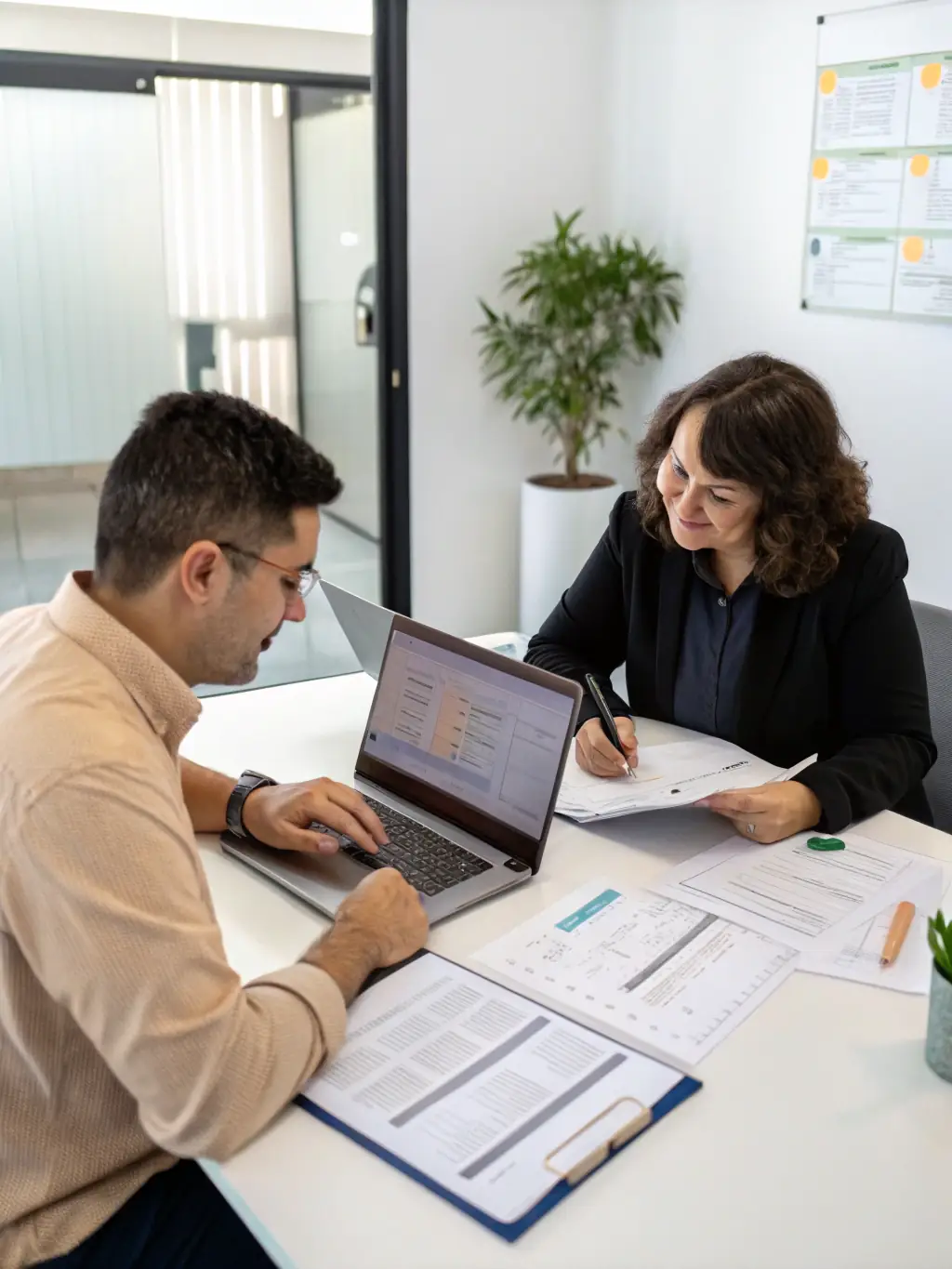 A friendly accountant advising a small business owner in a modern office setting, showcasing personalized accounting solutions.